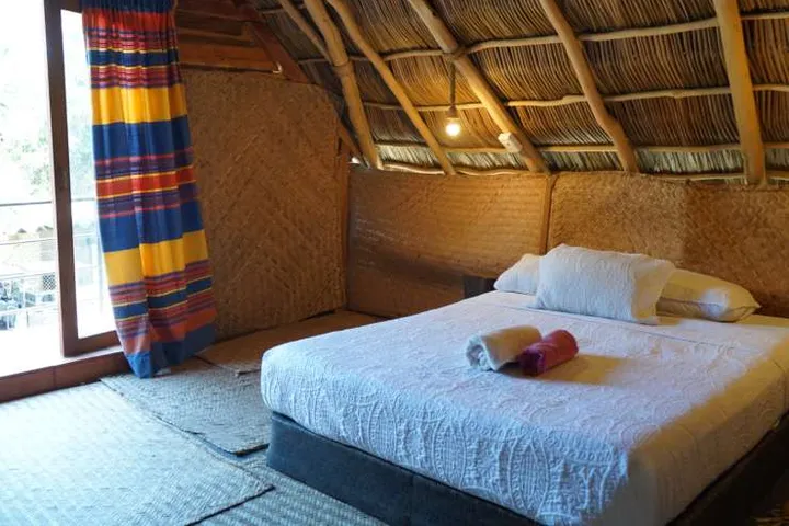 The street-facing balcony of the White Cabin, under the palms
