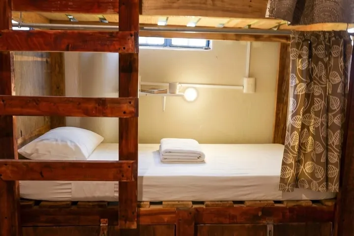 Bunks with privacy curtains in one of La Redonda’s shared dorms